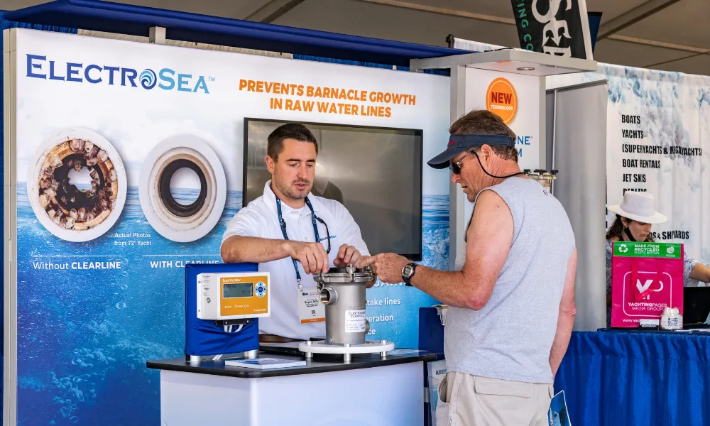 Exhibitor for "Electrosea" discussing the product with a customer 